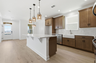 kitchen with wood flooring, wood cabinets, and white countertops