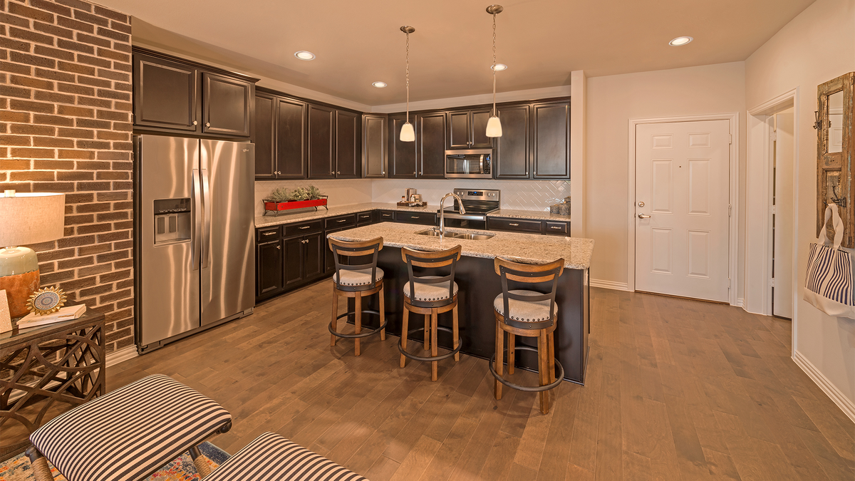 open kitchen with large island and wood floors