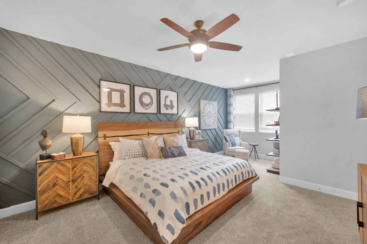 primary bedroom with carpet floors and ceiling fan