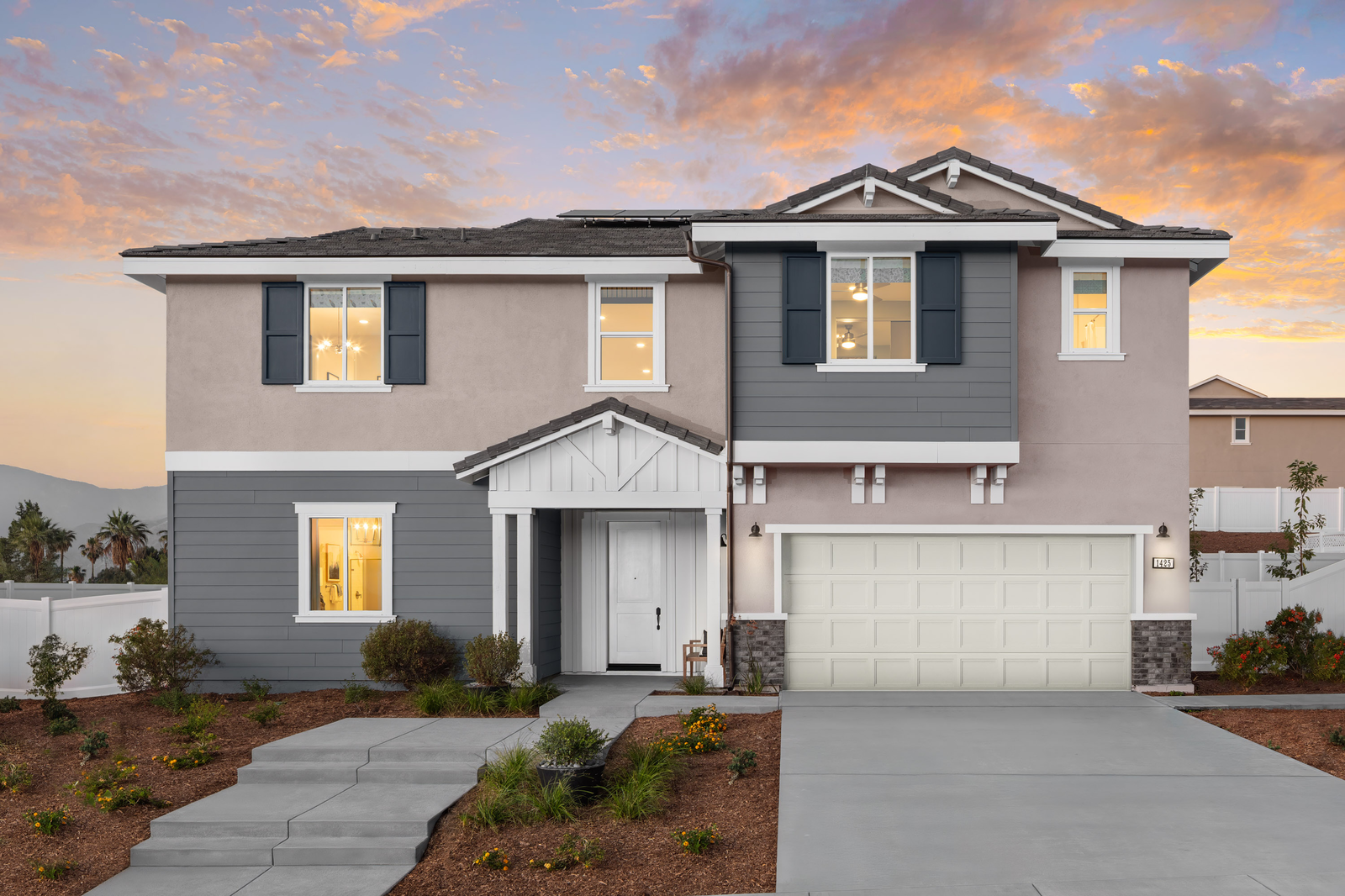 two-story exterior with a white windowless garage and multiple windows 