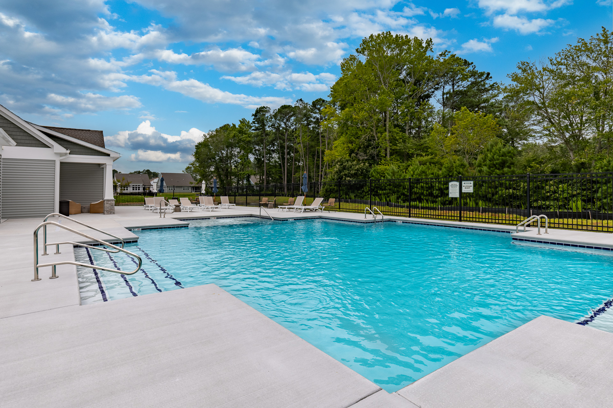 pool with surrounding lounge chairs and tables