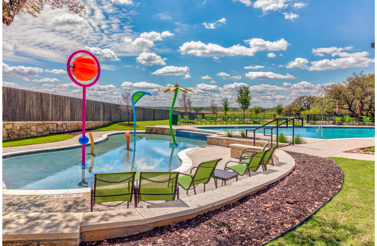 pool with splash pad and lounge area 