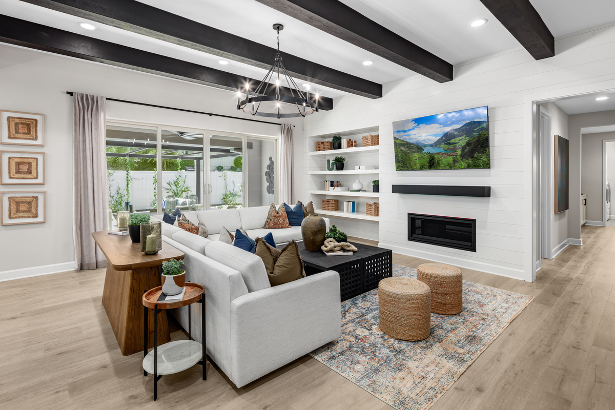 great room with dark beams and neutral floors