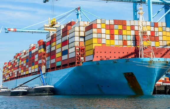 Cargo ship loaded with shipping containers at a harbor 