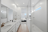 spacious bathroom with a large walk-in shower and double sink