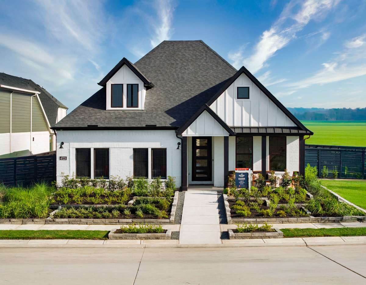 exterior white brick home with black window frames