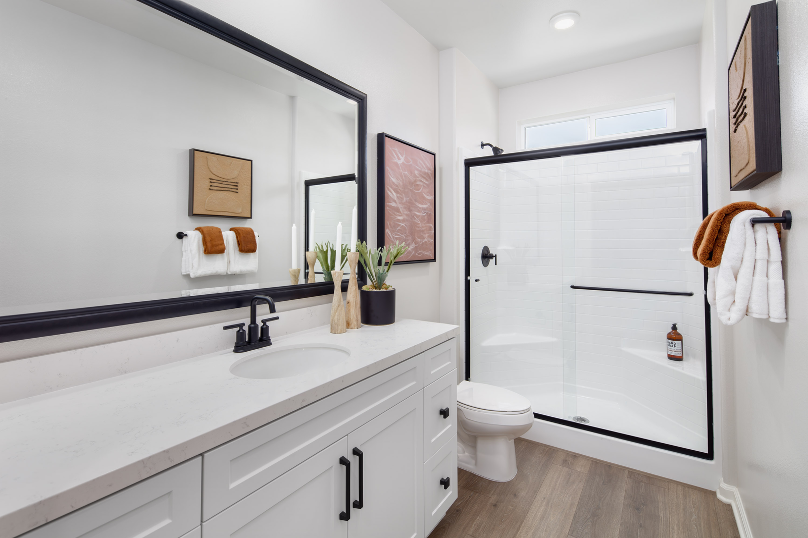 bathroom with neutral floors and white cabinets