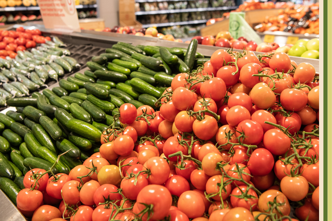 Tomatoes and cucumbers on display in Coles fresh food isle