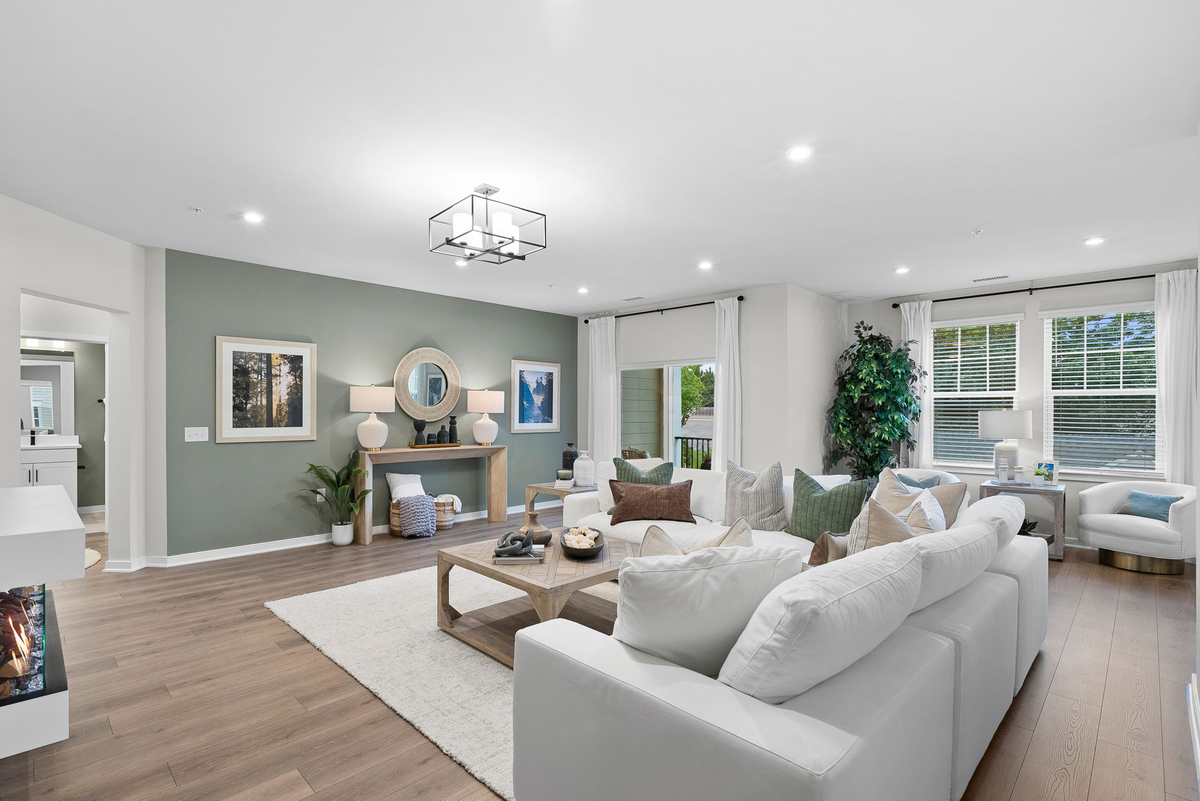 living room with sectional & green accent wall