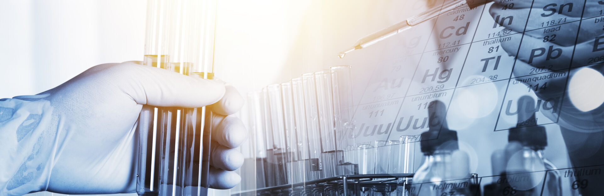 Image of a person holding test tubes in a lab