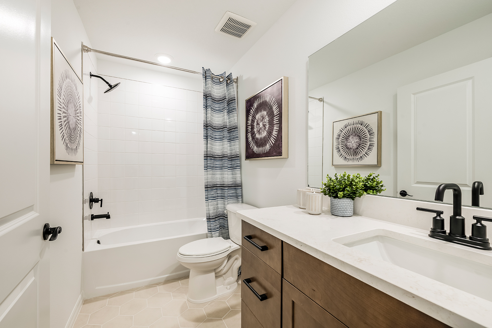 second bathroom with brown cabinets and shower and tub combo