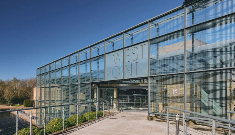 Exterior view of the West Point office building entrance on a sunny day.