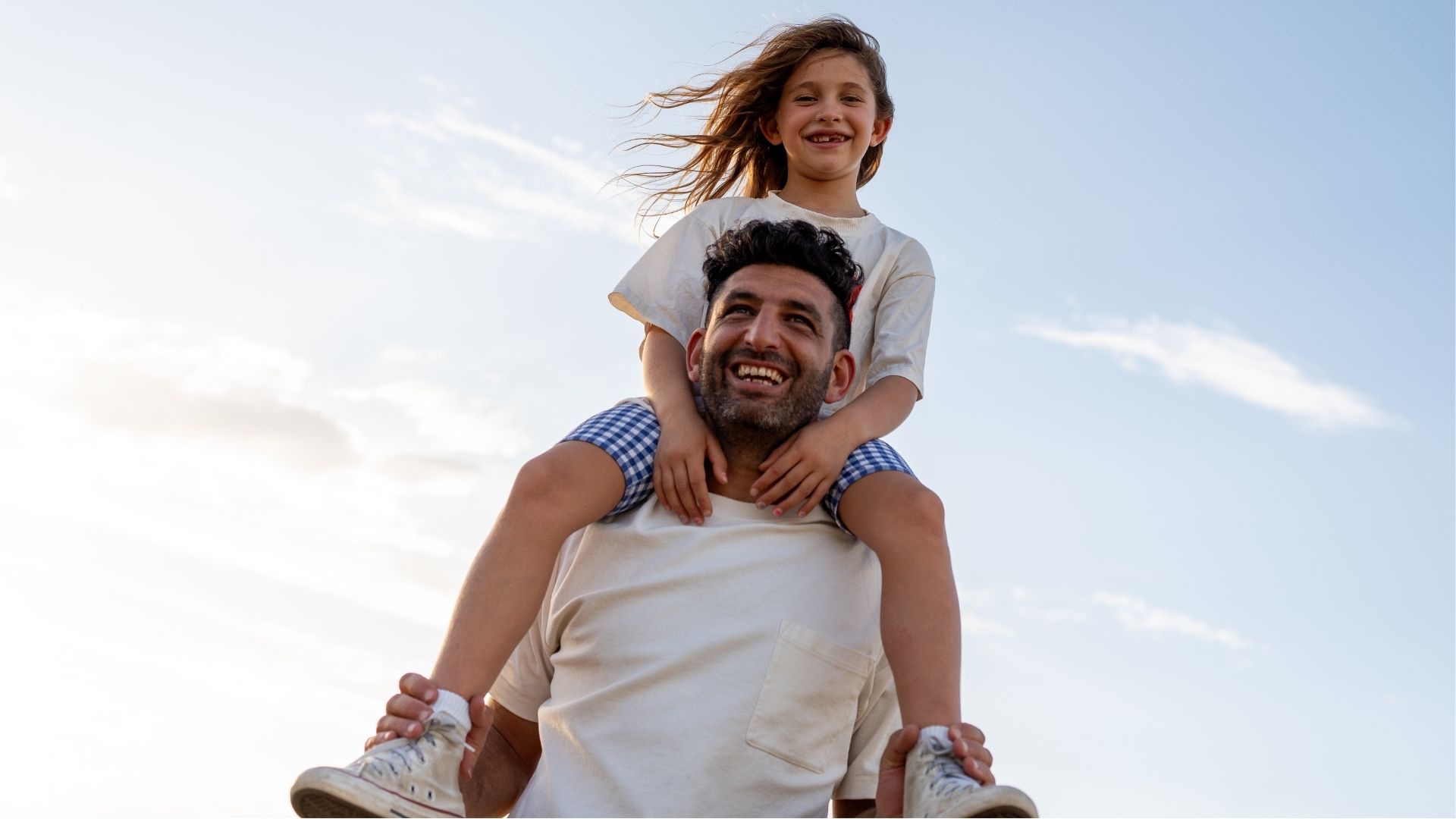 Dad and daughter on his shoulder.