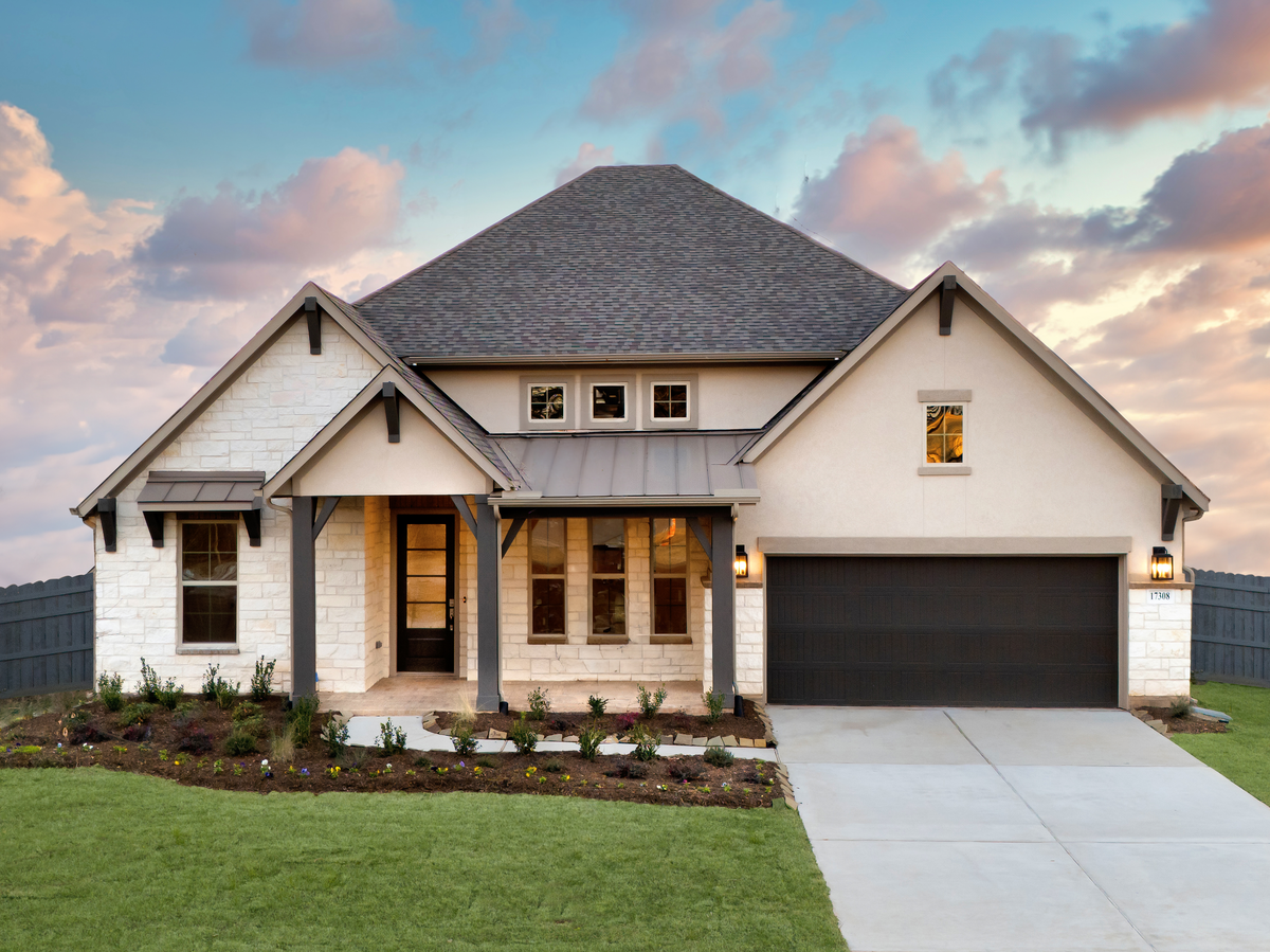 exterior with stucco, stone & 2-car garage