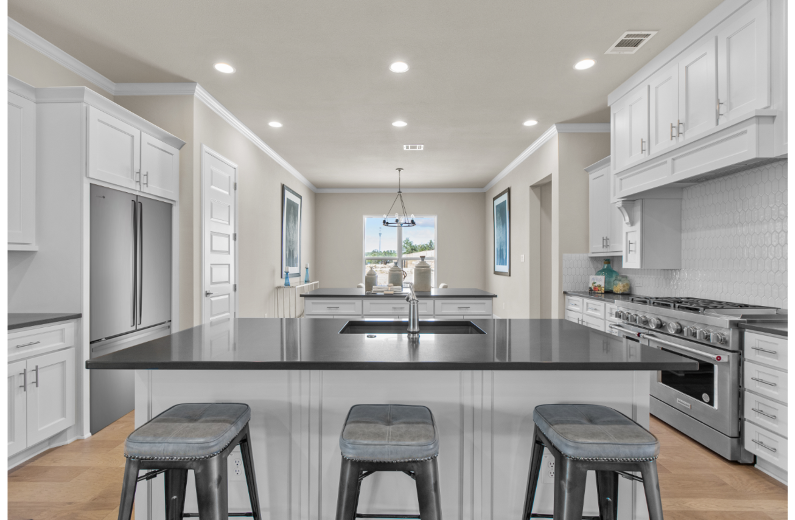 kitchen with two islands, a fridge & window