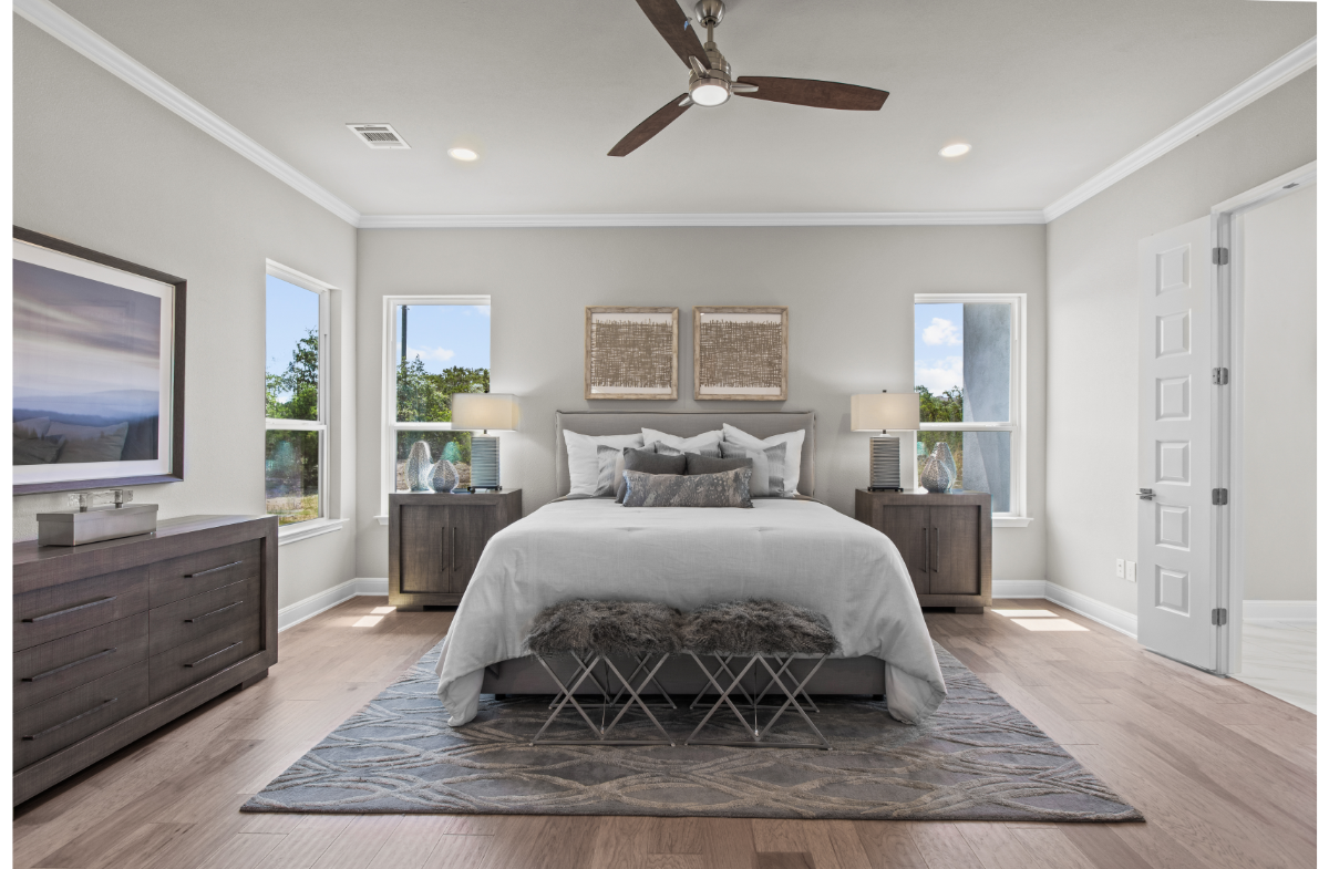 primary bedroom with bed, windows & nightstands 