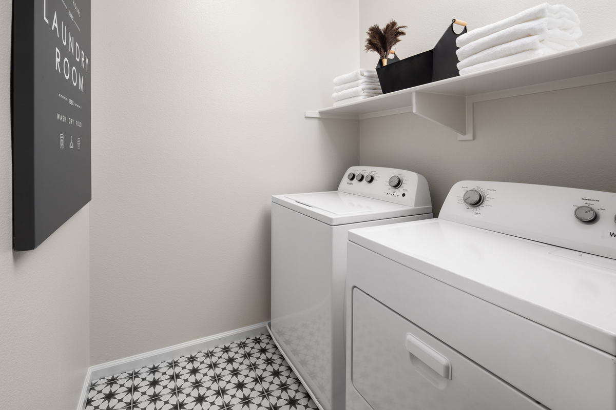 laundry room with geometric black tiles