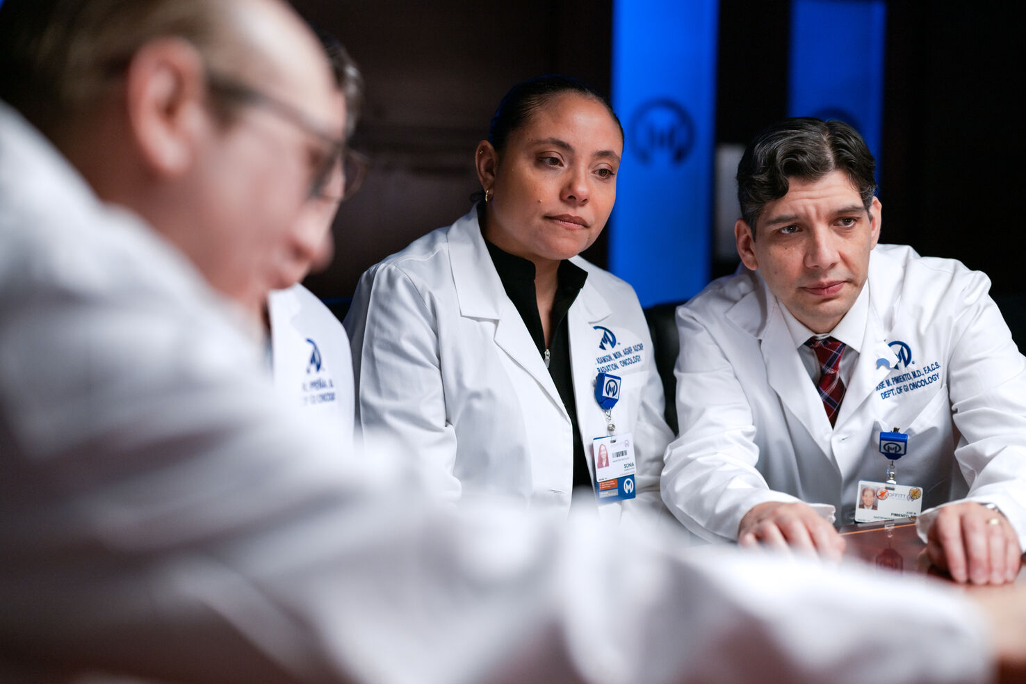 Jose Pimiento, MD, right, looks at a patient's case during the GI tumor board meeting.