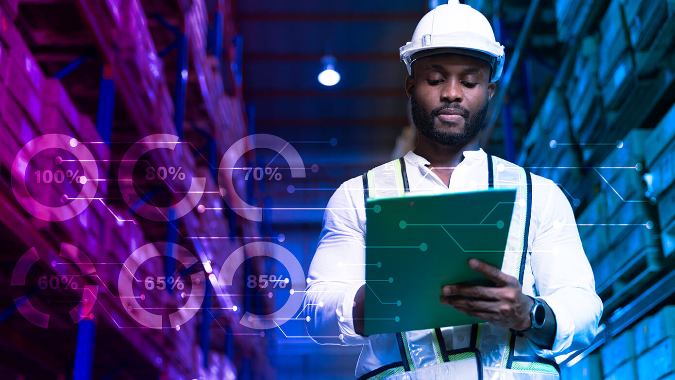 Man looking at a big tablet in a warehouse