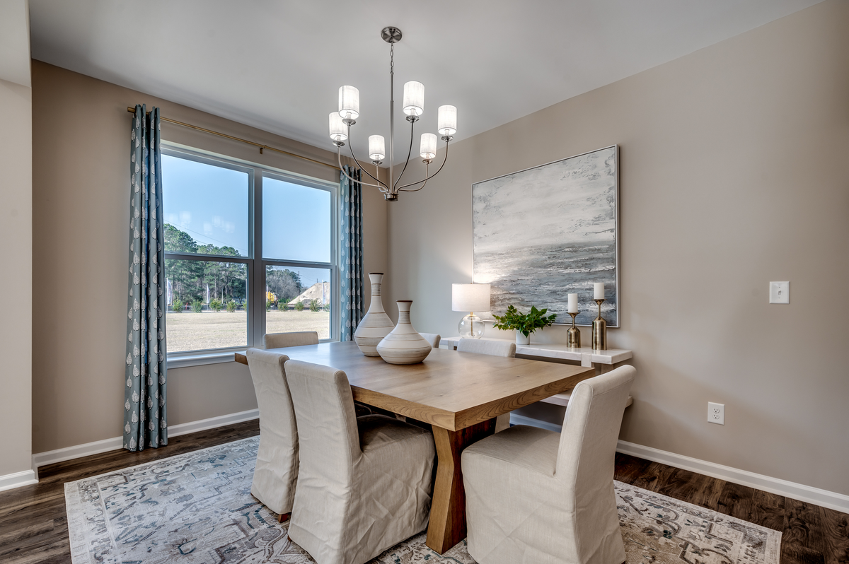 dining room with large windows and silver fixture