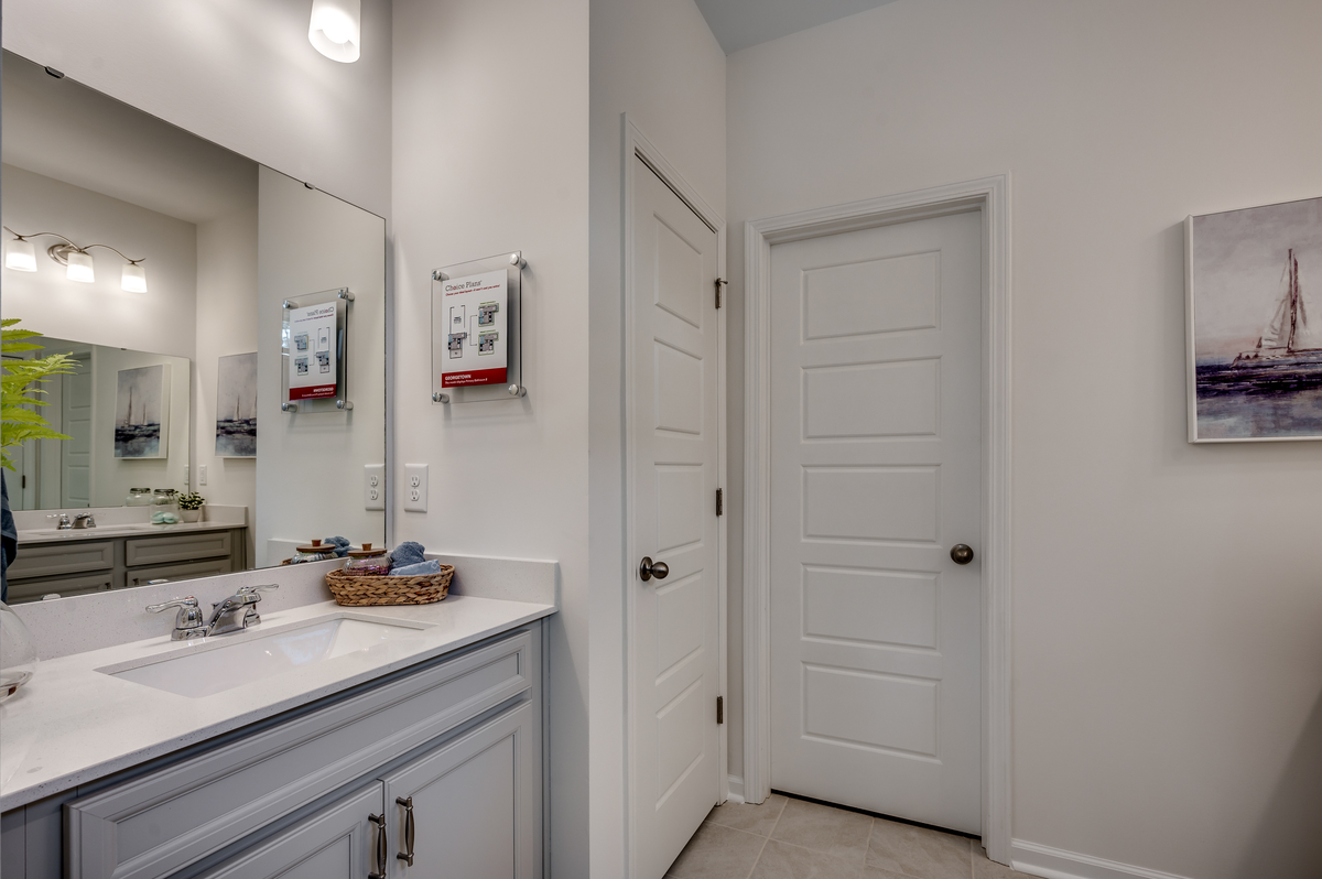 large bath with detached blue double vanities