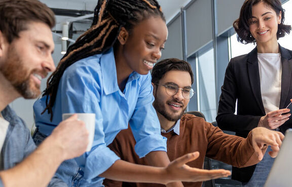 Group of diverse business people using laptop