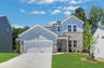 front of 2-story home with light brick and siding