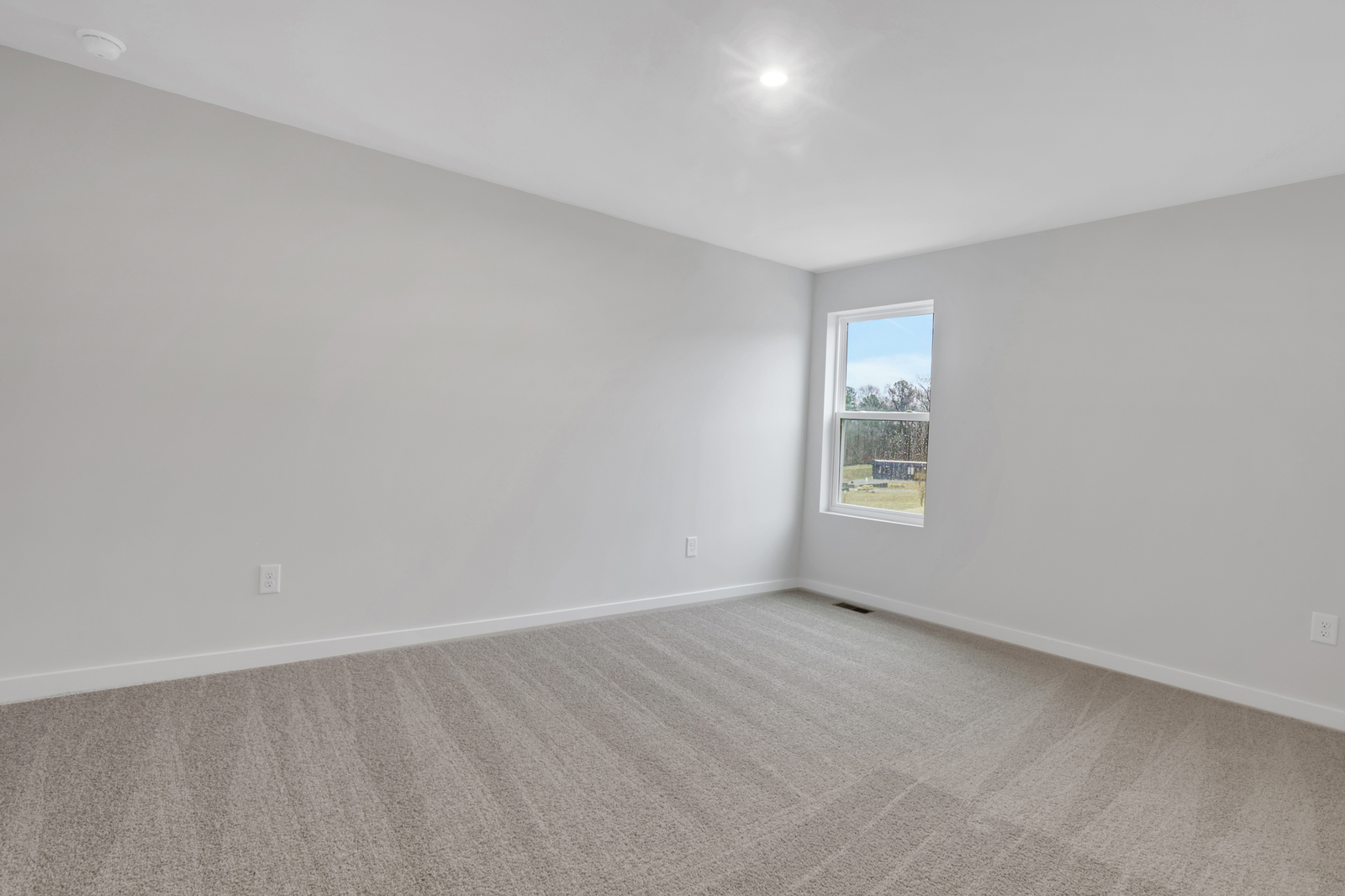 secondary bedroom upstairs with windows and carpet