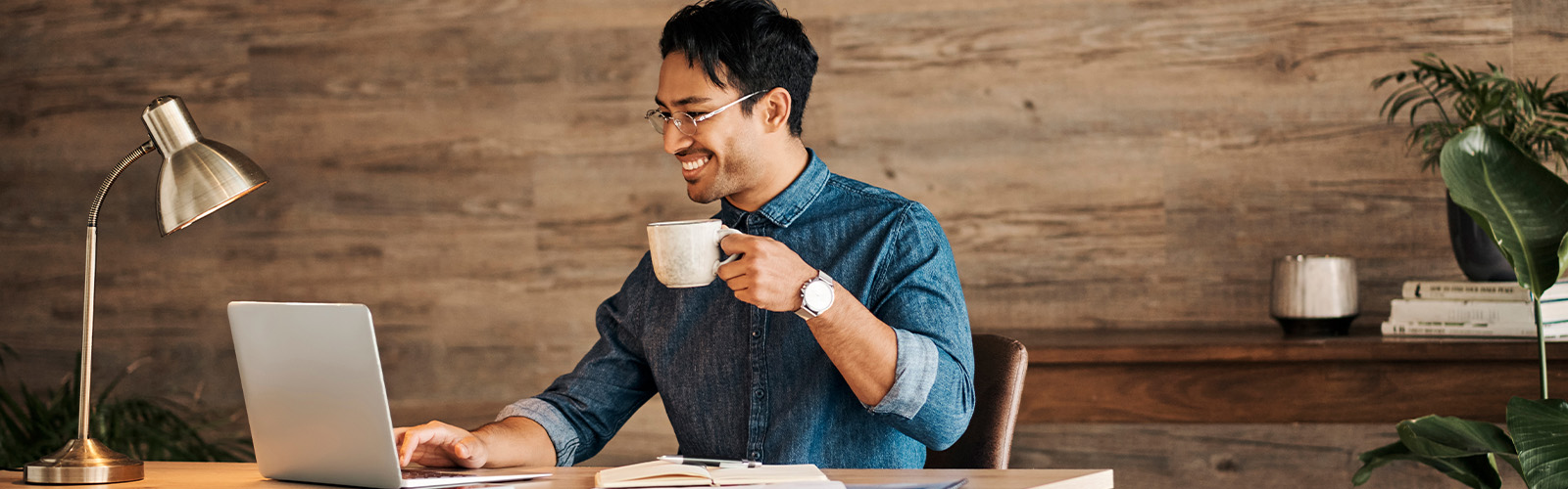 A man drinking coffee at a desk