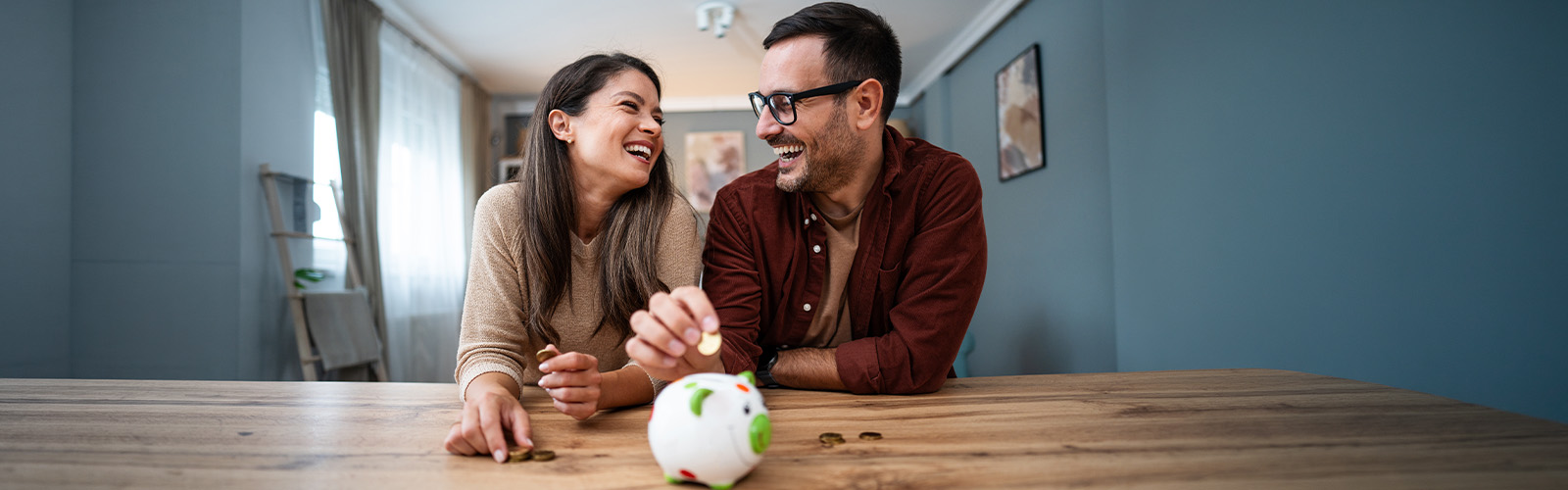 A smiling couple saving money