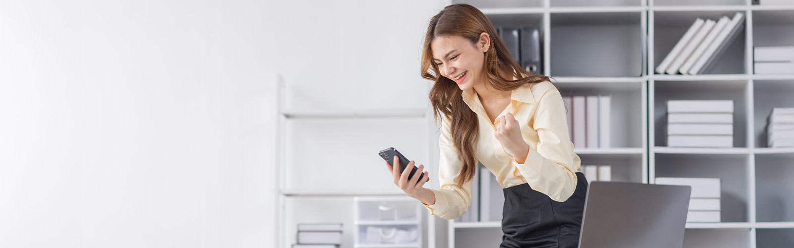 Young woman looking at her phone and smiling