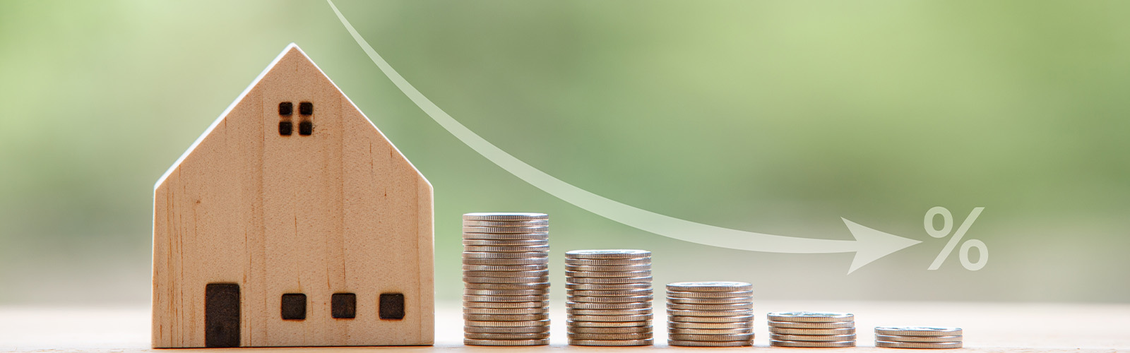 Toy house next to stacks of coins