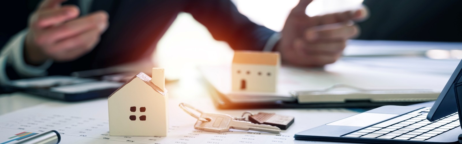A person at a desk with a calculator and a computer