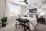 bedroom with neutral floors and accent wall