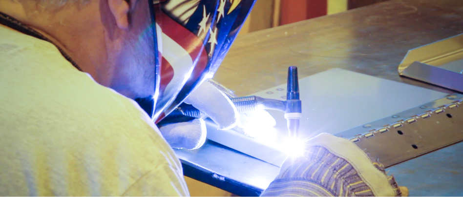 Lenco technician making a spot weld on a component