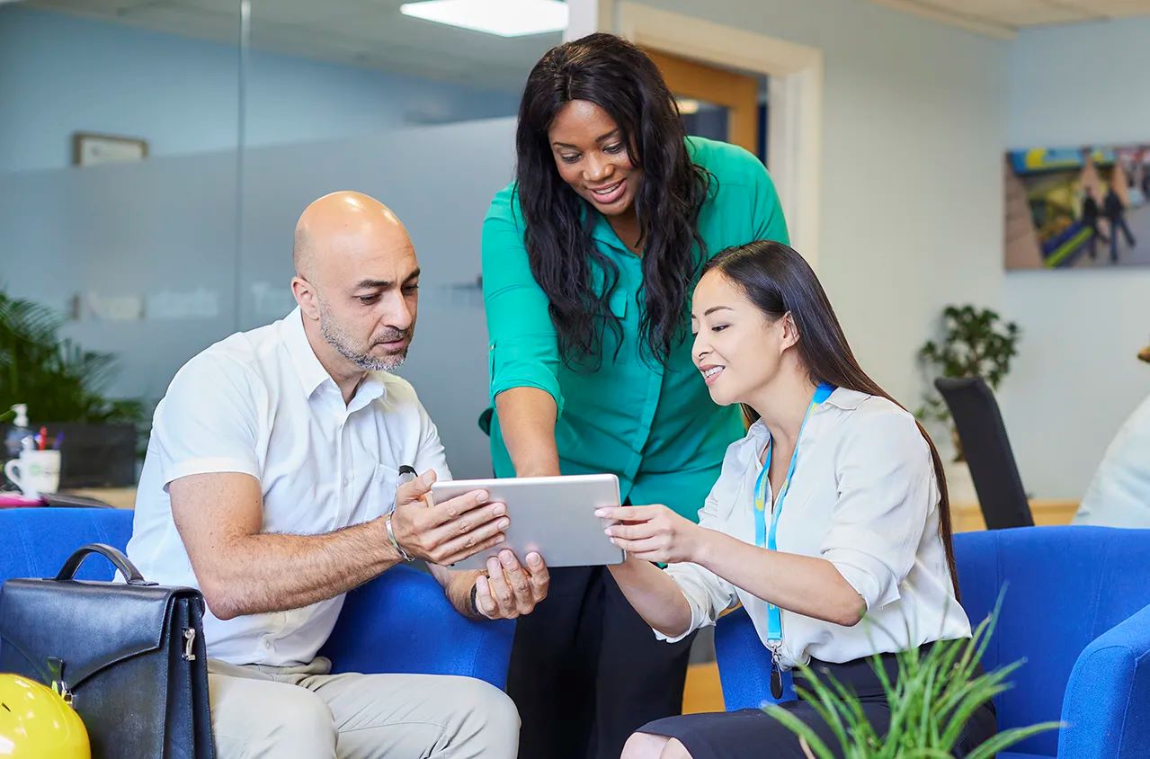 TaxAssist hero image - image of people around an ipad