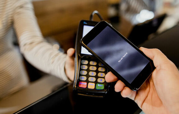 Customer paying for a transaction with a smartphone 