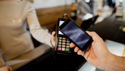Customer paying for a transaction with a smartphone 