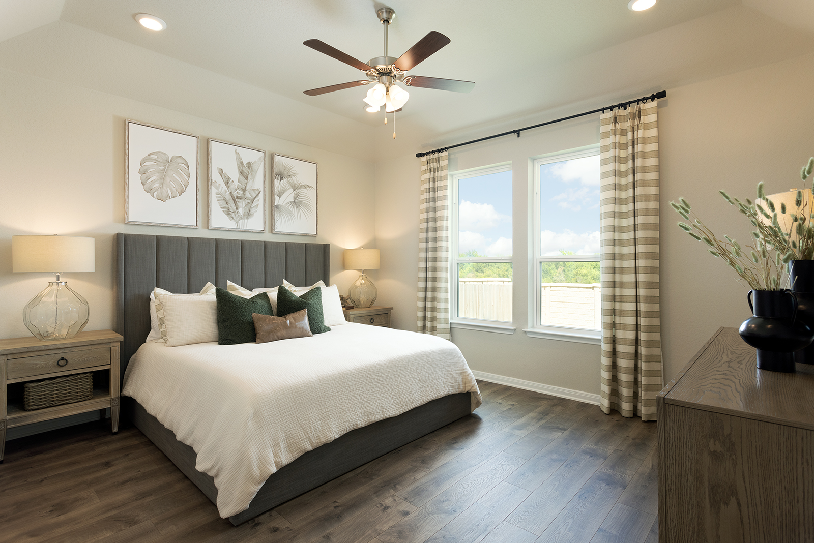 bedroom with large bed, windows & nightstand