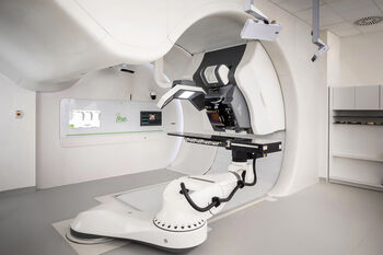 Side view of Proteus ONE proton beam therapy machine and treatment room.