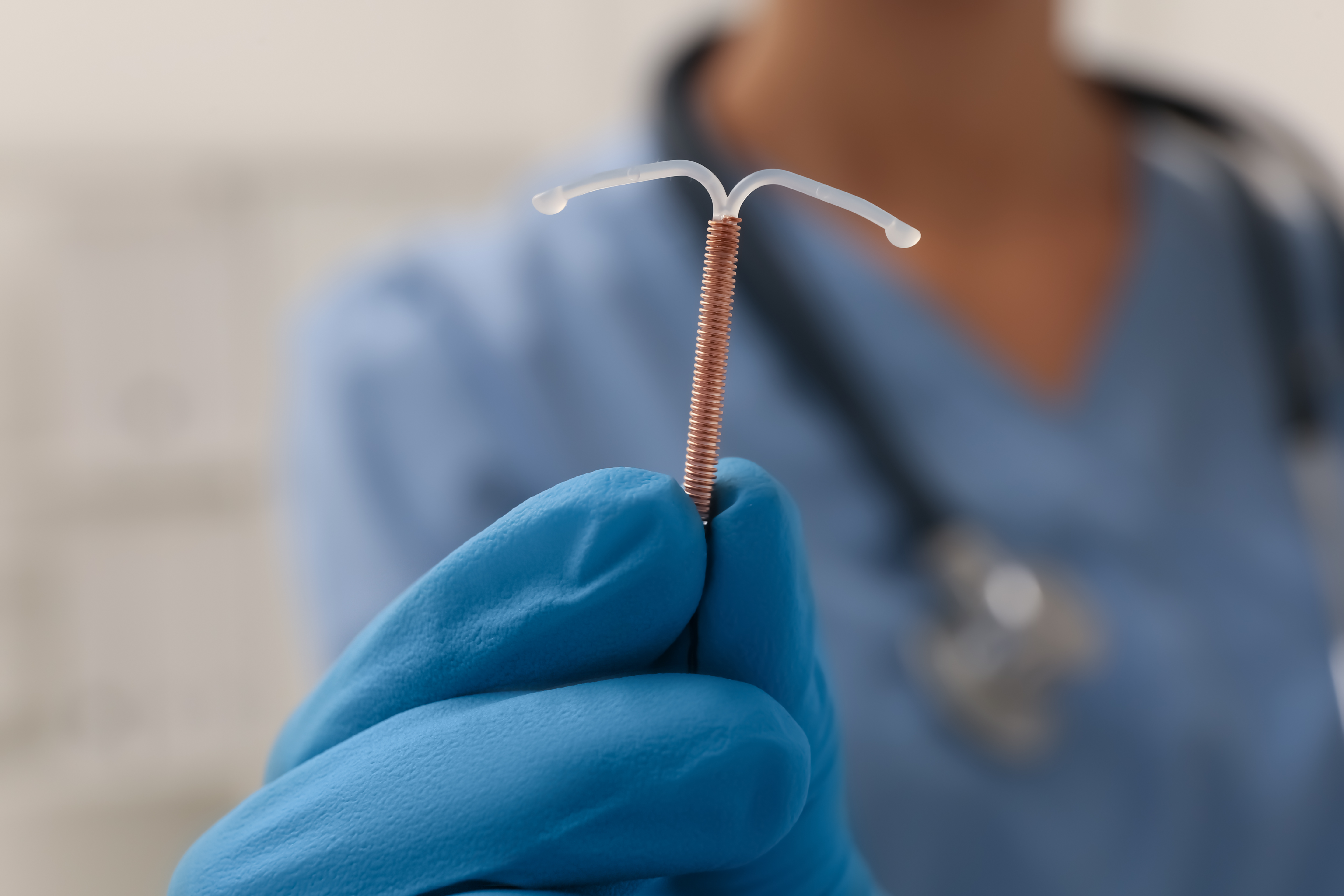 Doctor holding IUD