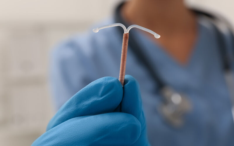 Doctor holding IUD