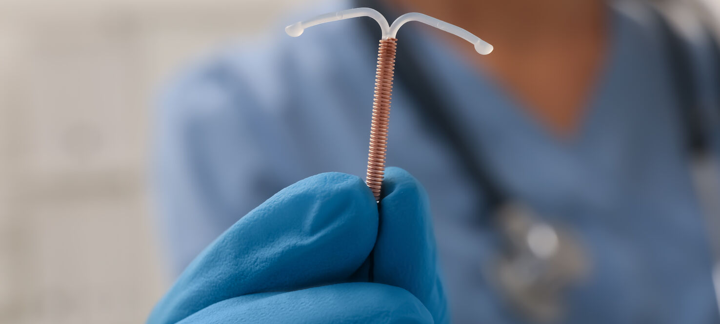 Doctor holding IUD