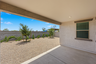 spacious covered patio with recessed lighting and views of a landscaped backyard with trees