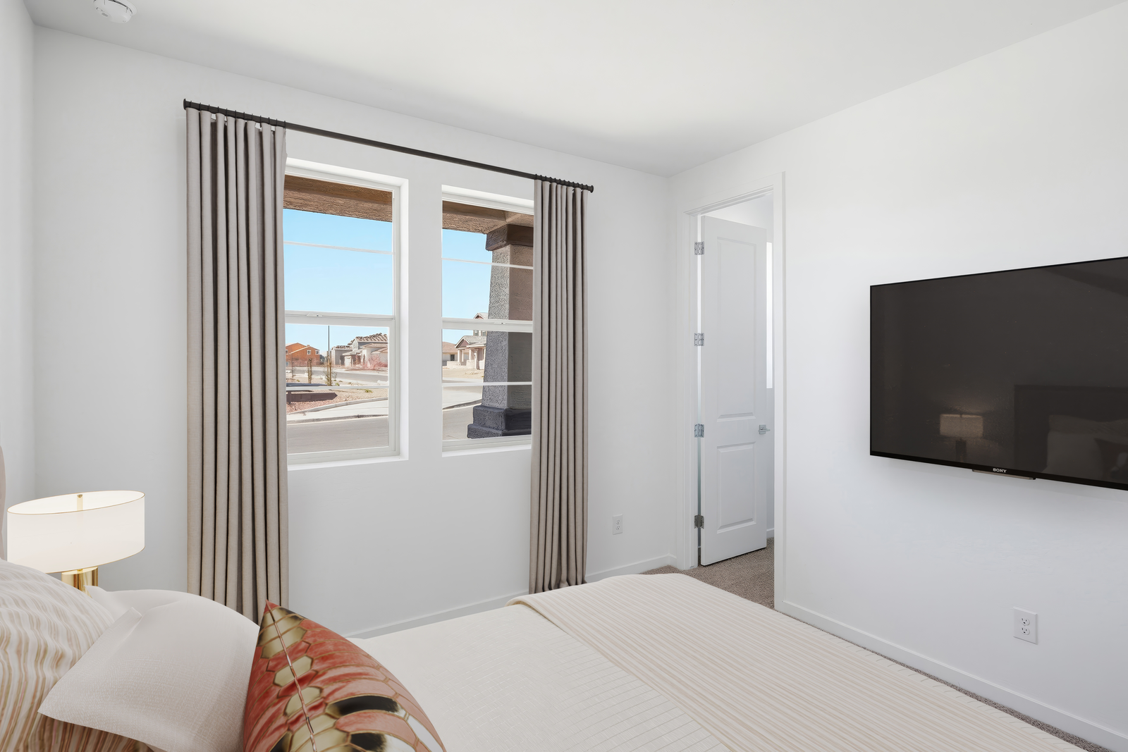 bedroom with a large bed and a neutral color palette.