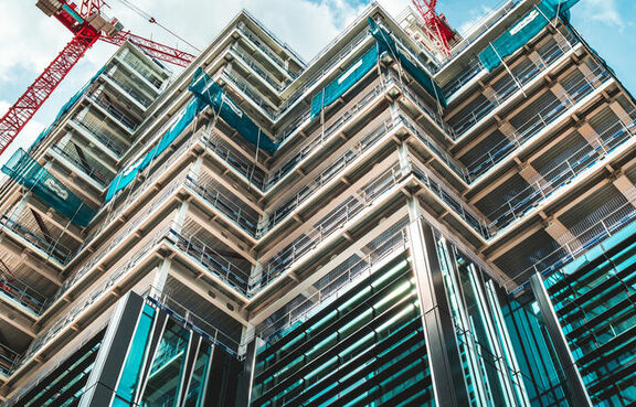 Upward view of a tall building under construction