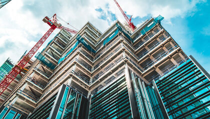 Upward view of a tall building under construction