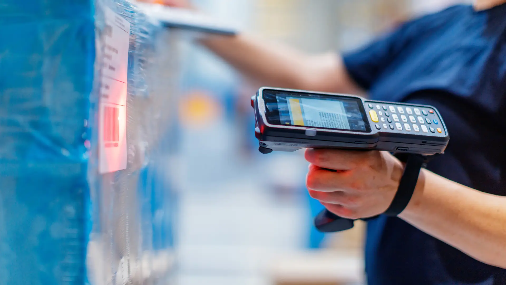 Person holding a scanner in a warehouse