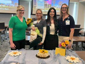 Kathy Cramer, a certified medical assistant in Blood Draw at Moffitt McKinley Outpatient Center, celebrates receiving a 2026 midyear Sunflower Award with Moffitt leaders.