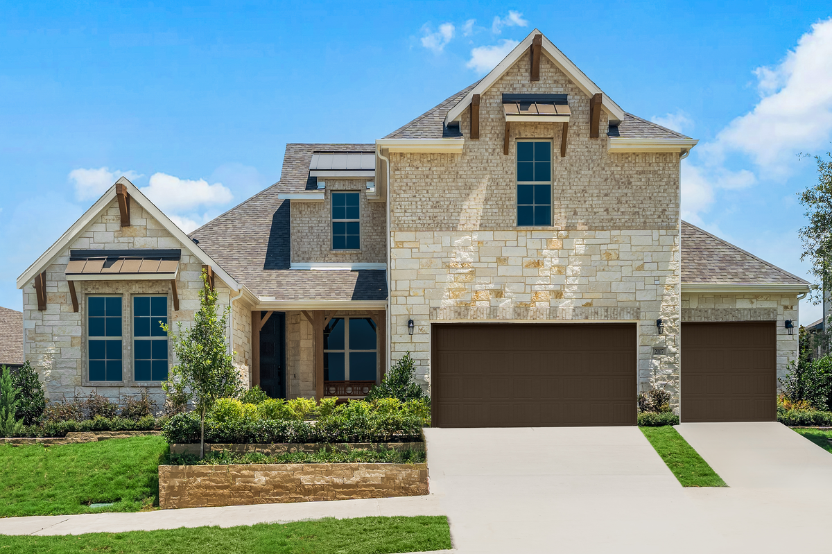 brick and stone exterior with small tree